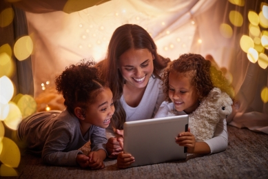 Mother with children looking at laptop