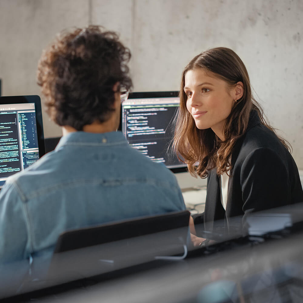 Male and female engineers talking