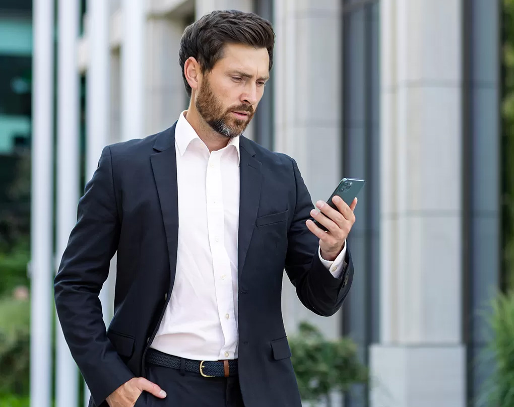 business man looking into his mobile phone