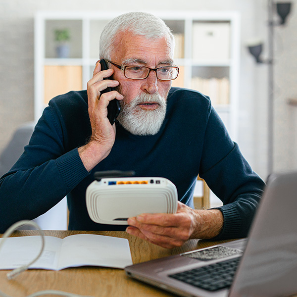 Senior man calling customer service for internet and router connection problem